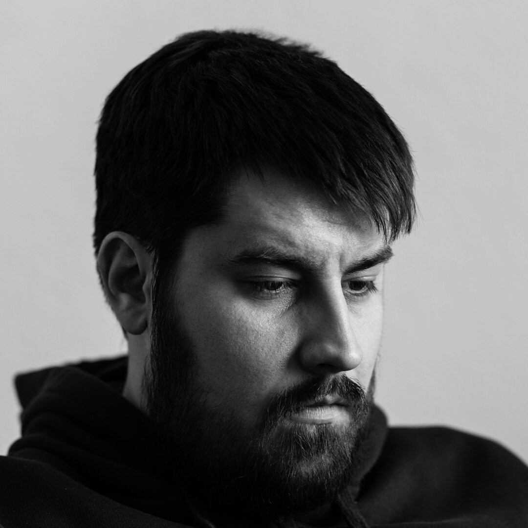 Studio portrait of a man with short beard smiling