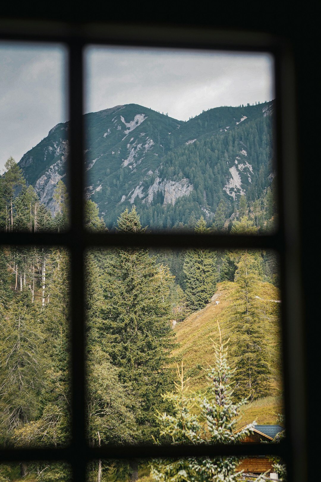 Luxury hotel suite with large window overlooking mountains